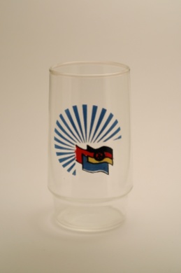A water glass with the flags of the GDR, Soviet Union and the GDR's youth organization, the Free German Youth (photo: R. Newson).